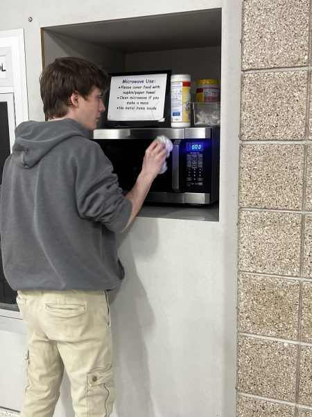 There is now a microwave in the commons for high schools to use during lunch time. Student Council member Braden Berndt taking his turn to clean the microwave. “I am thrilled that we were able to make a change. Although it may be small, it came from a group of people that wanted to make something happen! Through votes and discussion we made this possible and I am so happy that we made a positive change for our school,” Co-president of Student Council Aleea Lichtenberg said. 