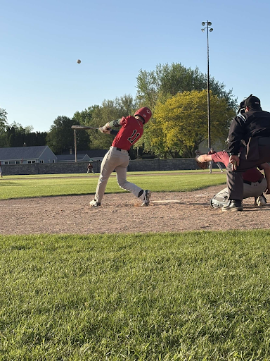 Senior Kale Bending scores a hit against Kewaskum at home on May 15. Bending has been playing baseball for about 14 years. 