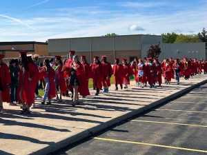 The 2025 seniors walk back to the high school after their senior walk at the elementary school, waiting for them on the other side is the middle school band.