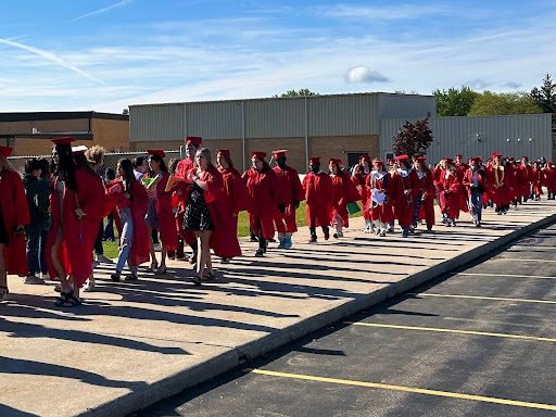 The 2025 seniors walk back to the high school after their senior walk at the elementary school, waiting for them on the other side is the middle school band.