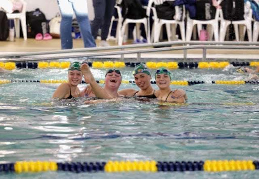 Left to right: sophomore Anna Schliepp, senior Kyla Manata, sophomore Alexia Pacurar, and senior Peyton Zamzow all place first at the Chilton Triangular event. Schliepp in the 200 and 500 free events, Manata in the 100 breast, Pacurar in the 200 IM and 100 fly, and Zamzow in the 50 free.