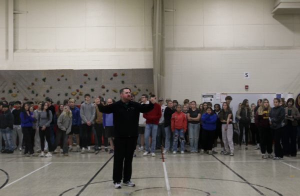 Principal Bryant Bednarek directs high school students to the doors they may exit from after the annual safety drill walk to Clay Lamerton’s little gym on Oct. 30. Science teacher Ben Sanderfoot has been the high school representative of the District Safety Committee since its creation in 2017. “I appreciate that our school district places a high priority on keeping everybody safe,” Sanderfoot said.