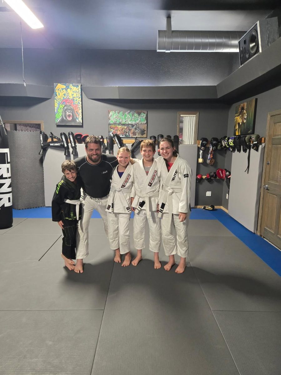 Left to right: Abdiel Spitler (brother), Adam Spitler (father), Nora Spitler (sister), freshman Uriah Spitler, and sophomore Ella Spitler. Uriah Spitler and his family gathered for a post-session photo after earning their second stripe. Students get the chance to advance in difficulty after collecting accomplishments. 
