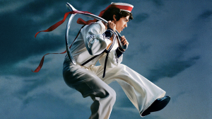 Caption: Conan Gray’s fourth studio album, “Wishbone,” released on August 15, 2025. The album cover, photographed by Dillon Matthew, features Gray in a sailor outfit, floating mid air, with a ribboned wishbone on his shoulder.