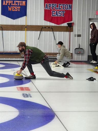 Science teacher Paul Bell delivers the curling stone at Appleton Curling Club on Thursday,  Feb. 5, 2026.  
