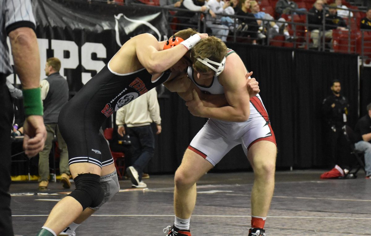 Junior Benjamin Green pushes into his opponent at the WIAA State Individual Wrestling Tournament taking place from Feb. 26-28.