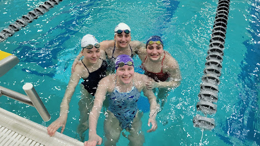 Sophomore Anna Schliepp (left) stands with Kiersten Dietschweiler (top), Etta Yonke (right), and Emalee Cavill (bottom). Here she swam with the girls at nationals in Greensboro, North Carolina. “To get to this point, I just had to swim really fast,” Schliepp said. 	

