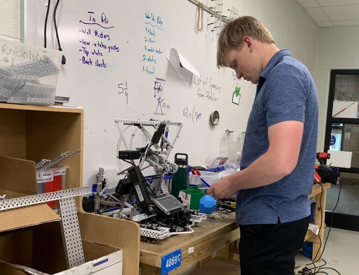 Senior James Paskey works on the bot “Birthday Boy.” The team decided to update the bot in preparation for the World Championship. “We’ve completely redesigned the robot, reprogrammed everything. We’re trying to get ready to compete,” Paskey said.
