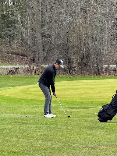 Junior Hudson Masters lines up a chip shot during an early season practice at the Mascoutin golf course in Berlin. "The most useful thing that I do in practice is when I focus on putting; it seems to translate the most," Masters said.
