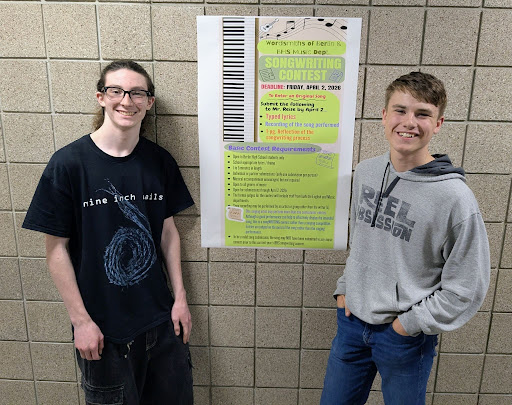 Left to right, sophomores Connor Emerson and Ewan Steffen stand beside the Wordsmiths of Berlin advertisement poster for the annual songwriting contest. The pair won first place for the second year in a row, receiving a $50 cash reward ($25 each).